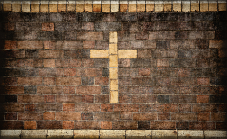 christian cross in brick wall